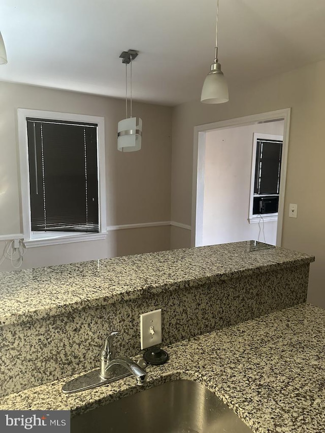 interior space featuring pendant lighting and sink