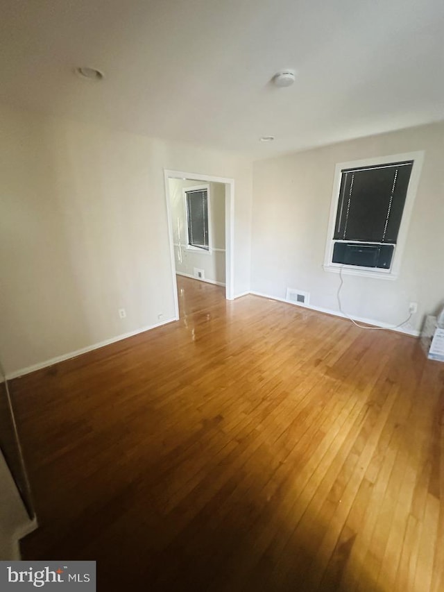 empty room with wood-type flooring