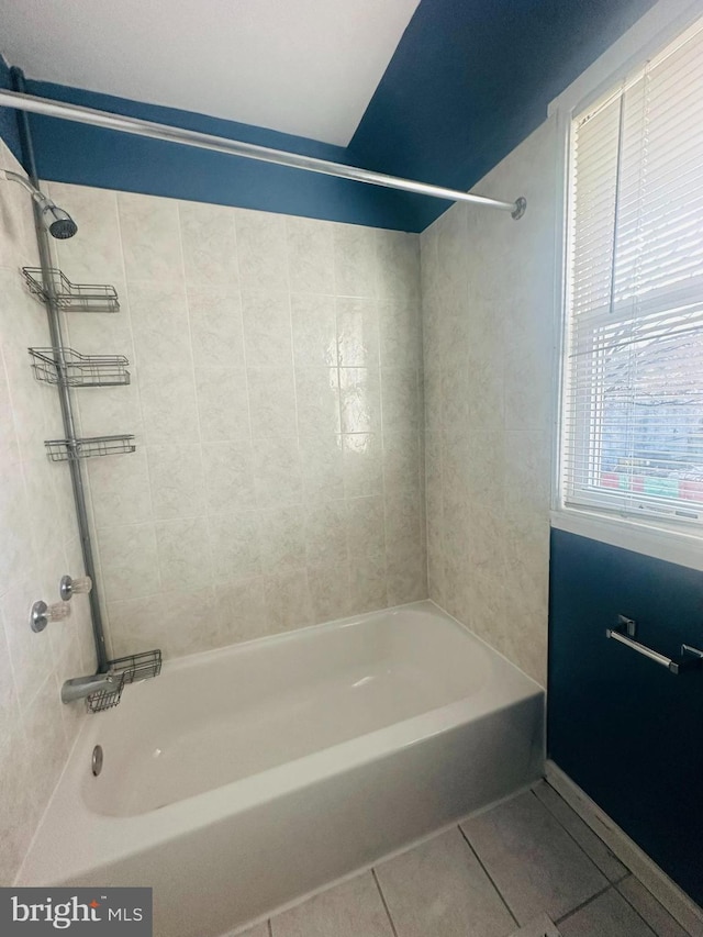 bathroom featuring tile patterned floors and tiled shower / bath