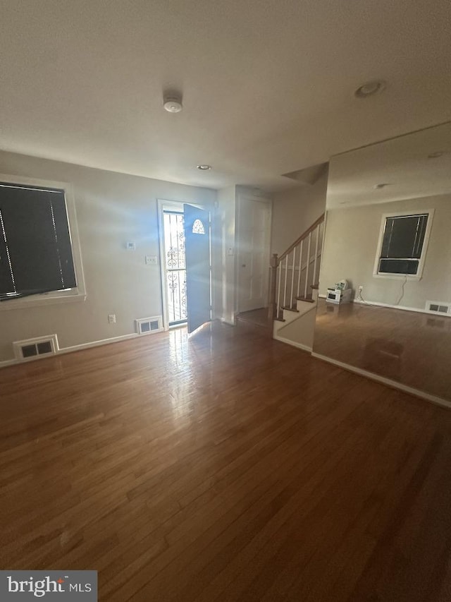 spare room featuring wood-type flooring