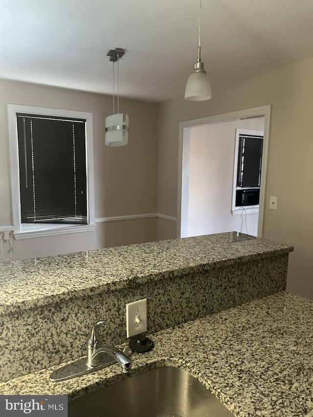 interior space with hanging light fixtures and sink