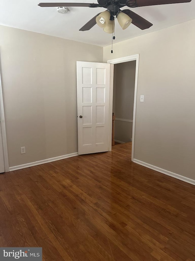 unfurnished bedroom with dark hardwood / wood-style flooring and ceiling fan