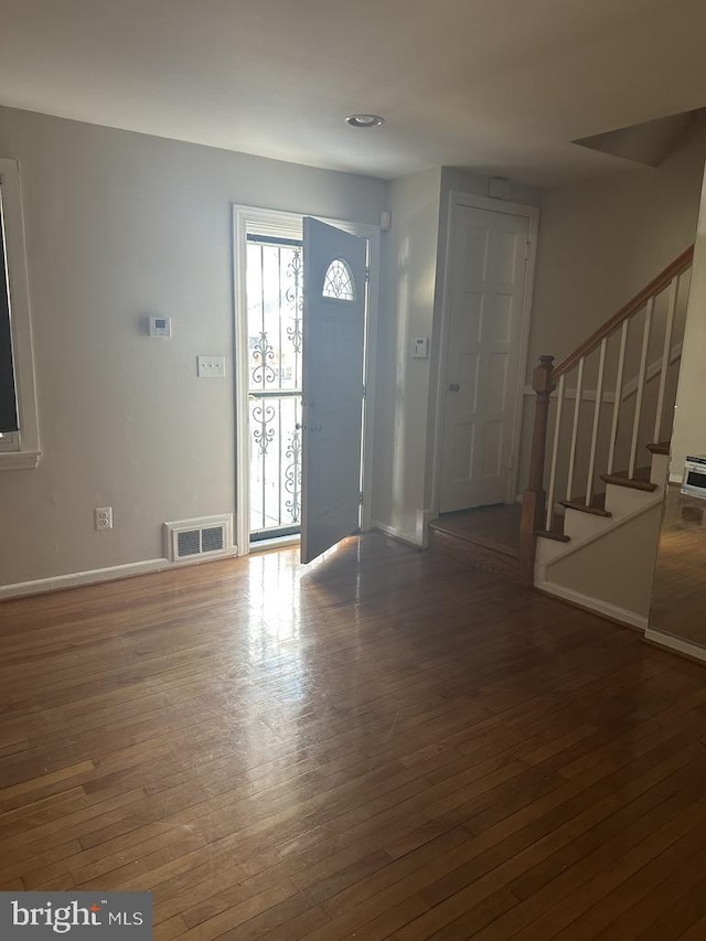 foyer with dark hardwood / wood-style floors