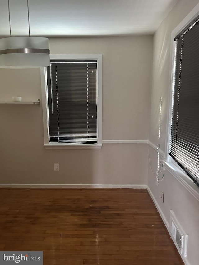 empty room featuring dark hardwood / wood-style flooring