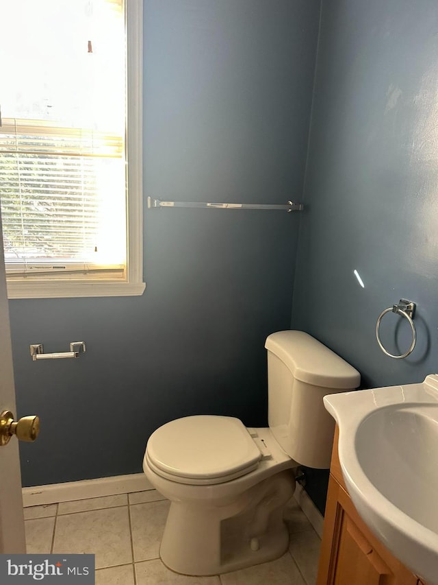 bathroom with tile patterned flooring, vanity, and toilet