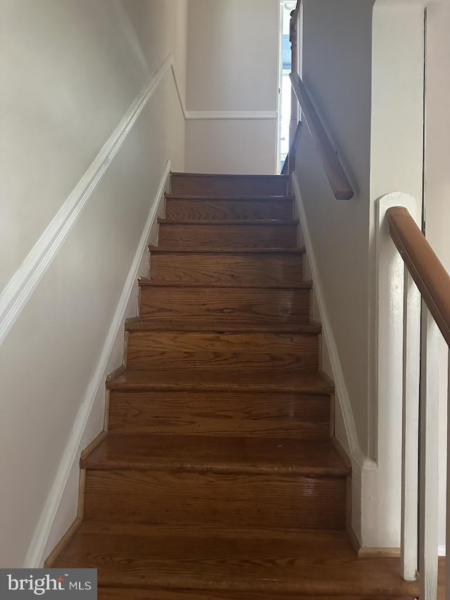 stairway with hardwood / wood-style floors