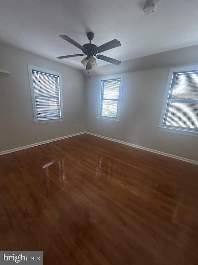 empty room featuring dark hardwood / wood-style floors and ceiling fan