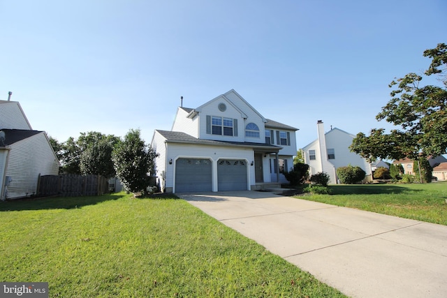 view of property with a garage and a front yard