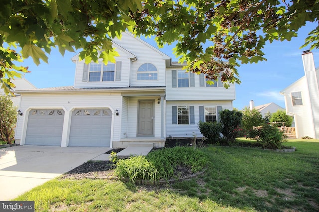 view of front of house featuring a garage and a front lawn