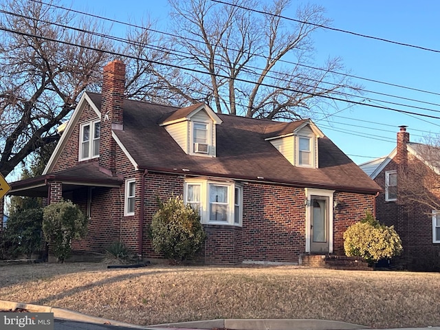 new england style home with cooling unit