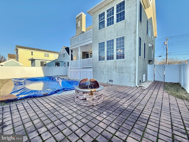 view of swimming pool featuring an outdoor fire pit