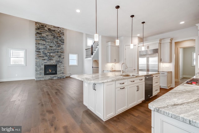 kitchen featuring white cabinets, pendant lighting, stainless steel appliances, and a spacious island