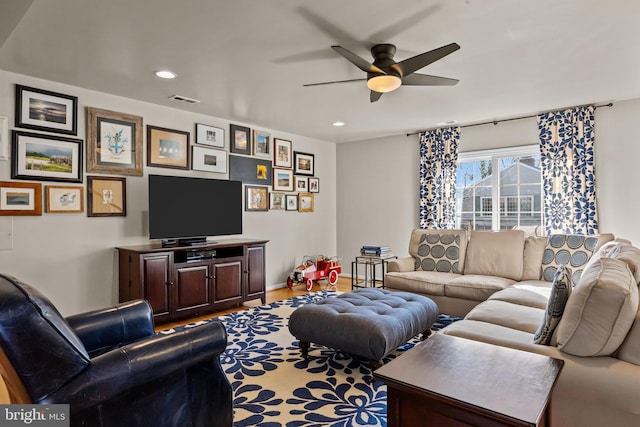 living room with hardwood / wood-style floors and ceiling fan