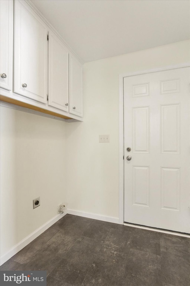 laundry room featuring electric dryer hookup and cabinets