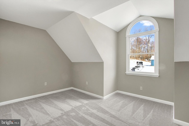 bonus room with light carpet and lofted ceiling