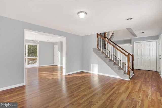 interior space featuring wood-type flooring and an inviting chandelier