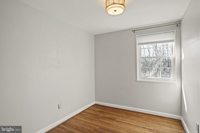 empty room with hardwood / wood-style floors