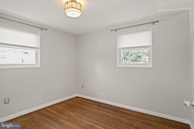 spare room with hardwood / wood-style floors