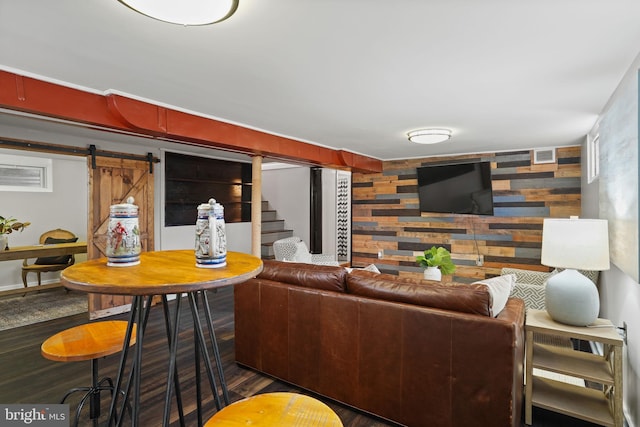 living room with dark wood-type flooring and a barn door