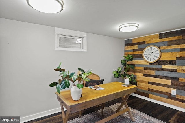 office space with dark hardwood / wood-style floors and wooden walls