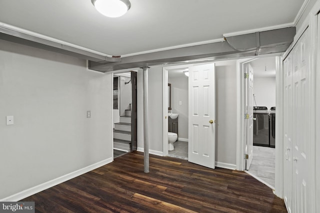 basement featuring dark wood-type flooring and independent washer and dryer