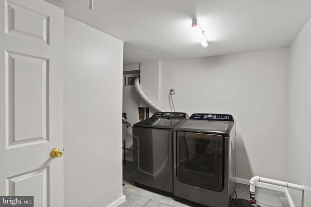 clothes washing area with independent washer and dryer