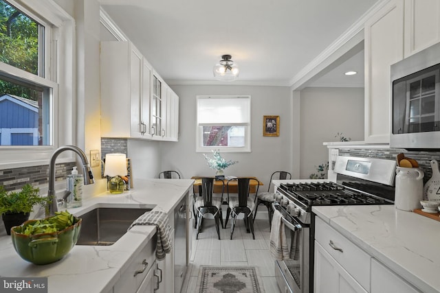 kitchen featuring stainless steel appliances, sink, and white cabinets