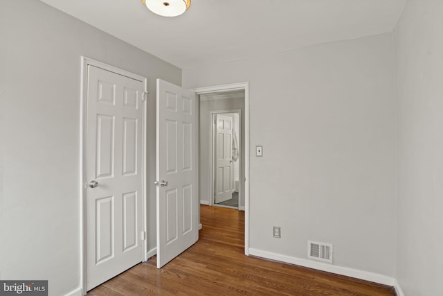 unfurnished bedroom with wood-type flooring