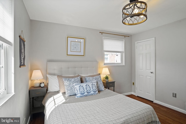 bedroom with dark wood-type flooring