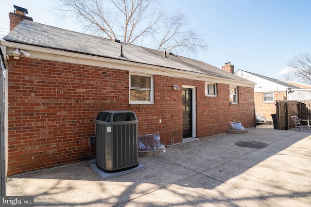 back of property featuring central AC and a patio area