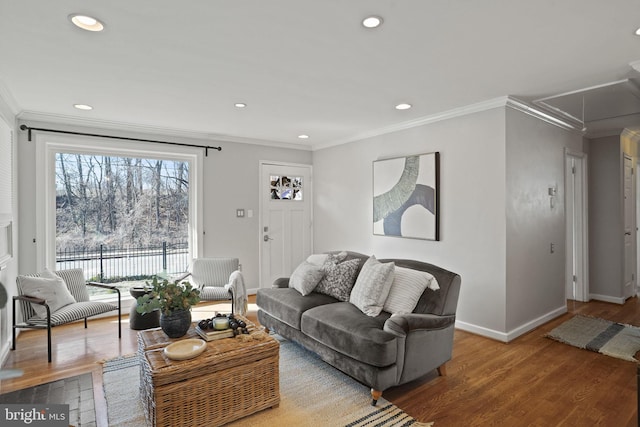 living room featuring hardwood / wood-style flooring and crown molding