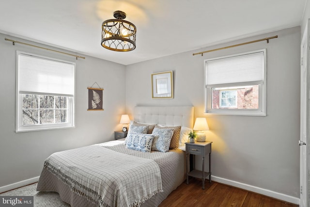 bedroom featuring dark wood-type flooring and multiple windows