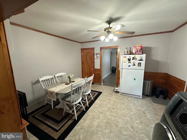 dining area featuring washer / clothes dryer, ceiling fan, and ornamental molding