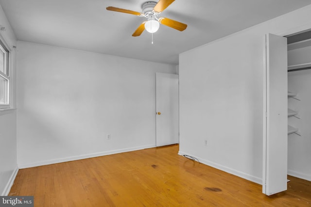 unfurnished bedroom with wood-type flooring, a closet, and ceiling fan