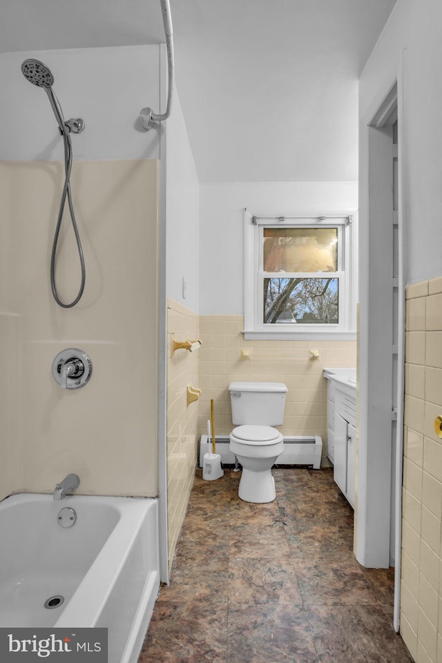 full bathroom with vanity, a baseboard radiator, and tile walls