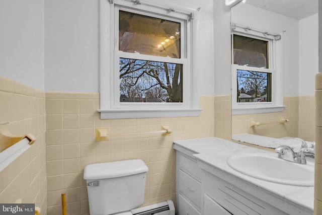 bathroom with baseboard heating, vanity, tile walls, and toilet