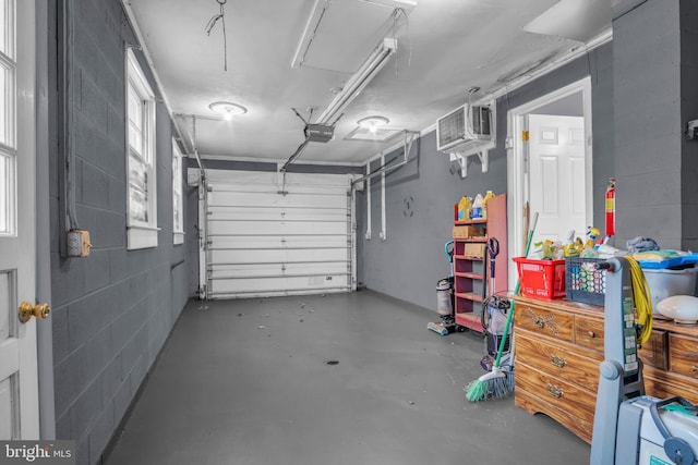 garage featuring a garage door opener and a wall mounted AC