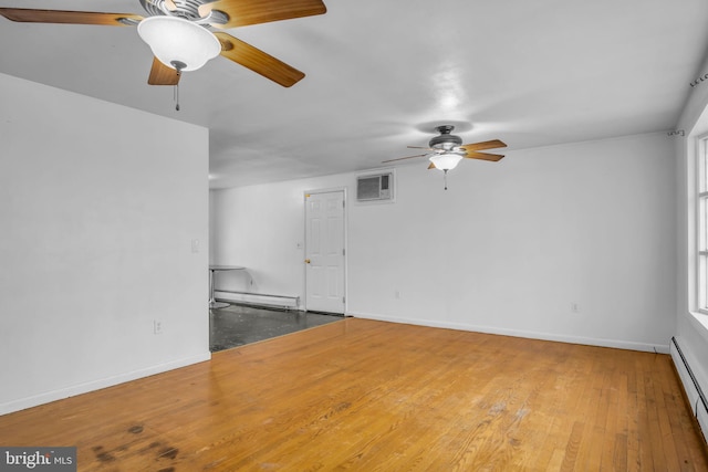 empty room with hardwood / wood-style floors, a baseboard radiator, and a wall mounted AC