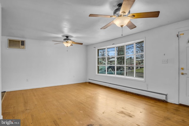 empty room with a wall mounted AC, light wood-type flooring, and baseboard heating