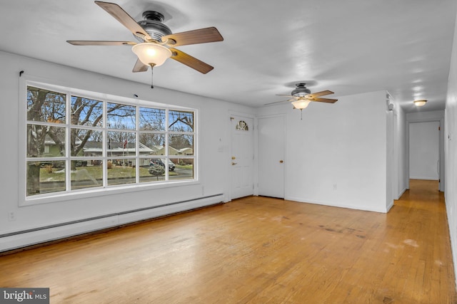 unfurnished living room with baseboard heating and light hardwood / wood-style flooring