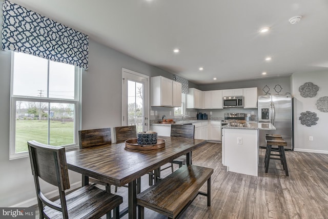 dining space with sink and hardwood / wood-style flooring