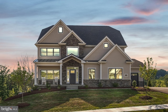 craftsman-style home with a yard