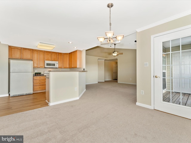 kitchen with light carpet, white appliances, ceiling fan with notable chandelier, crown molding, and hanging light fixtures