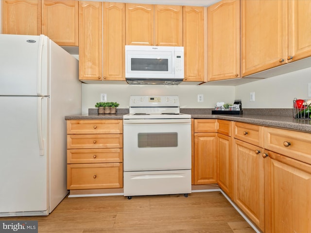 kitchen with white appliances and light wood-type flooring