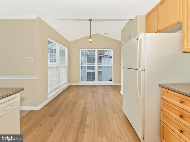 kitchen featuring light brown cabinets, hanging light fixtures, light hardwood / wood-style flooring, lofted ceiling, and white appliances