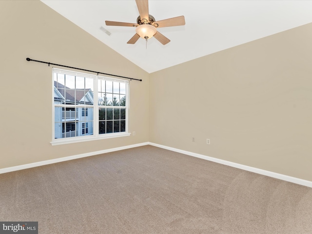 spare room featuring carpet floors, high vaulted ceiling, and ceiling fan