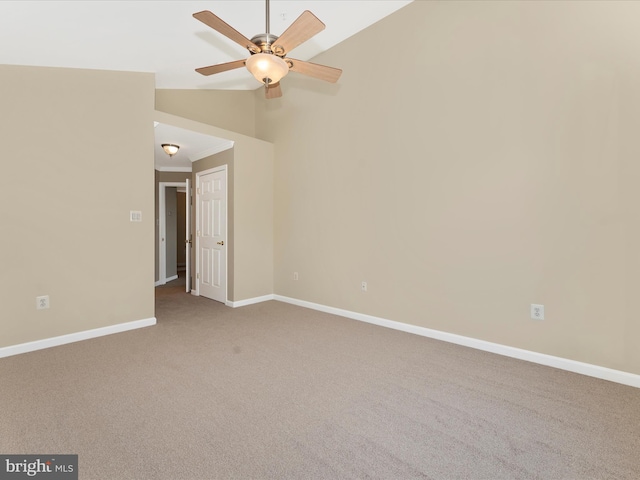 spare room with ceiling fan, light colored carpet, lofted ceiling, and crown molding