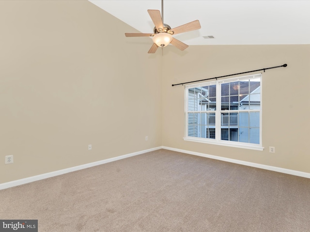 empty room with carpet, ceiling fan, and vaulted ceiling