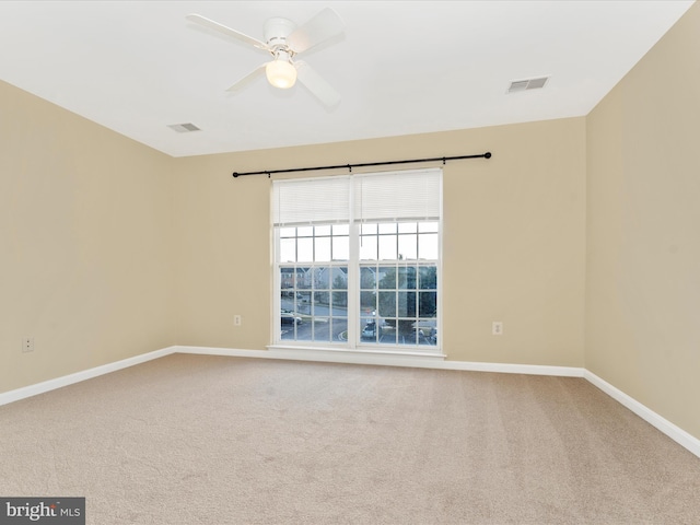 empty room featuring carpet and ceiling fan