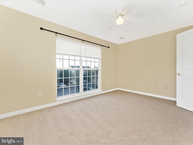 empty room featuring carpet flooring and ceiling fan